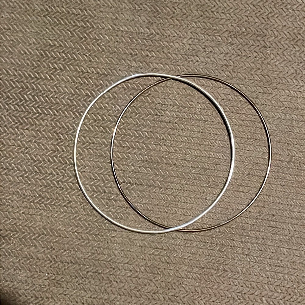 Paired silver hoop bracelets